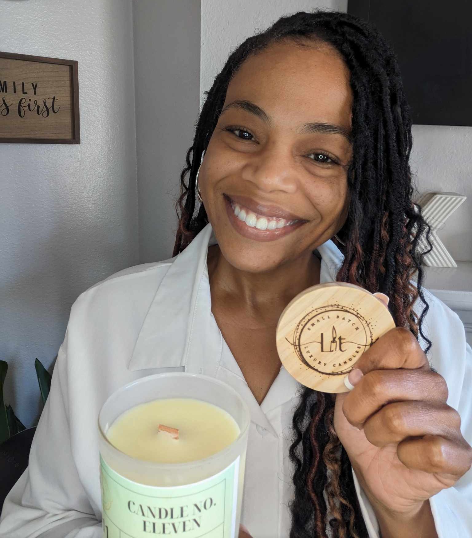 Brande Hutchinson of Lit Luxe Candle holds the bamboo top of one of her candles.
